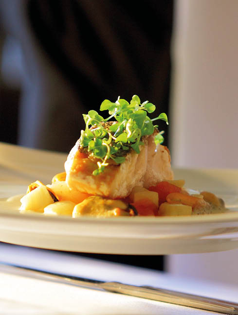 Soft focus Photo, clean, abstract, contemporary shot of waiter serving meal to a table 